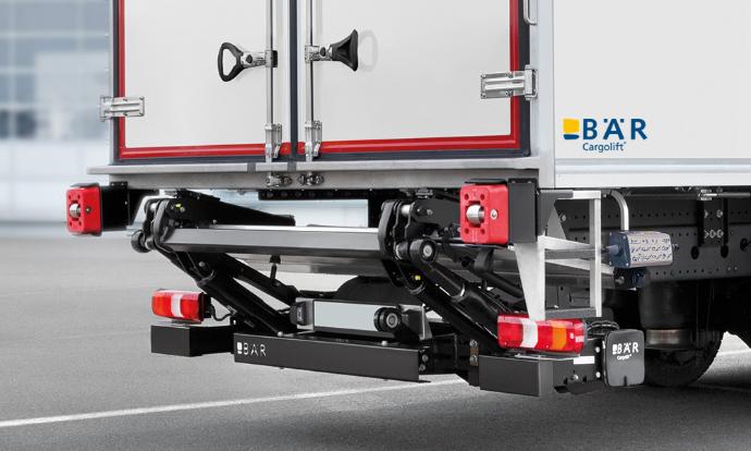 Onderklapbare Bar laadklep in rijpositie schuin onder de vrachtwagen